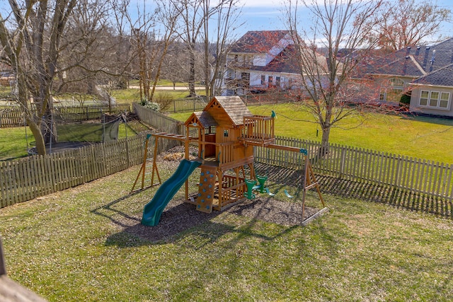 view of play area featuring a lawn and a fenced backyard