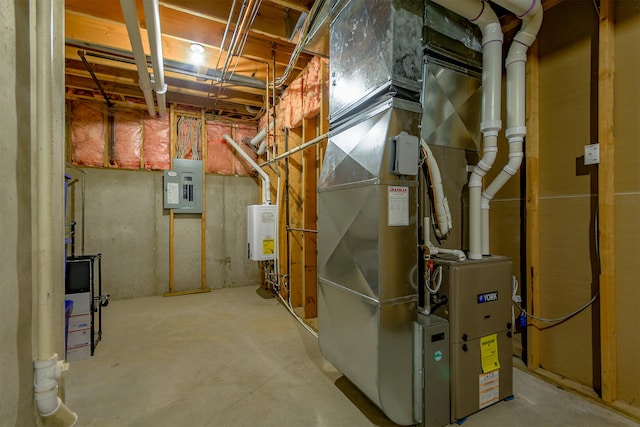 unfinished basement featuring electric panel and water heater