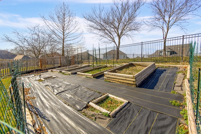 exterior space with a garden and fence