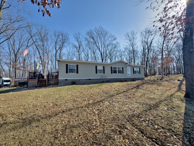 manufactured / mobile home featuring crawl space, a front lawn, and a deck