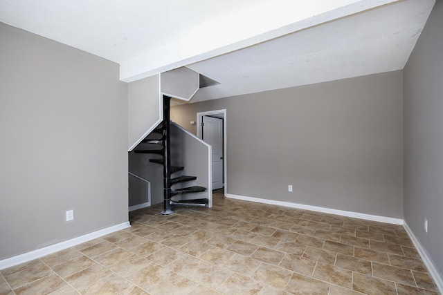 unfurnished living room with stairs and baseboards