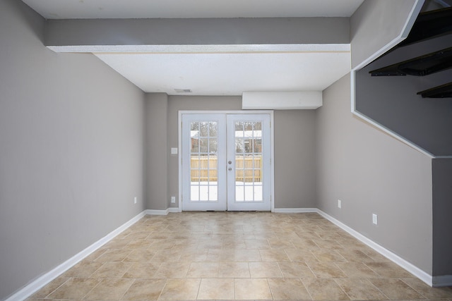 spare room featuring visible vents, baseboards, and french doors