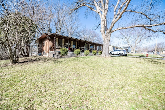 ranch-style home with covered porch and a front lawn