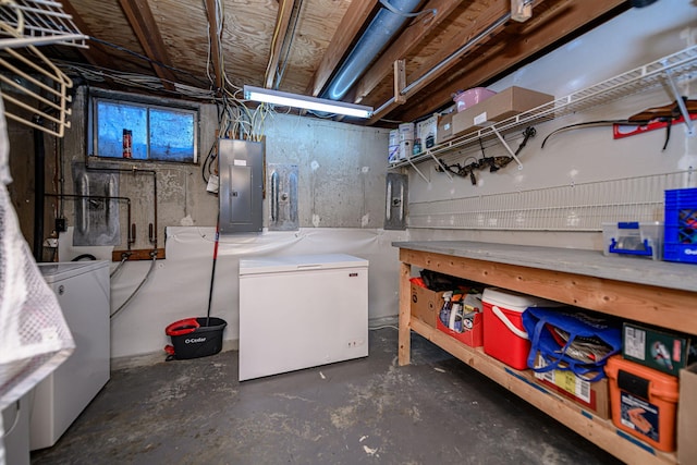 below grade area featuring electric panel and refrigerator