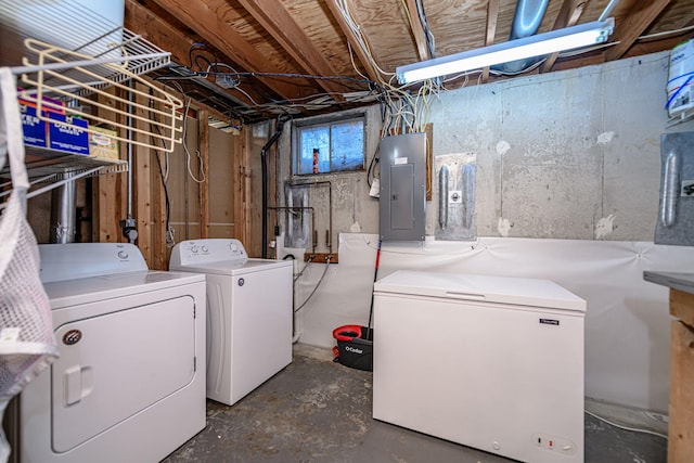 below grade area featuring white refrigerator, separate washer and dryer, and electric panel