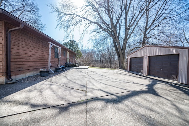 view of side of property featuring a detached garage and an outdoor structure