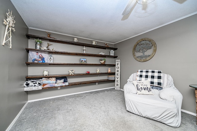 sitting room featuring baseboards, carpet, crown molding, and a textured ceiling