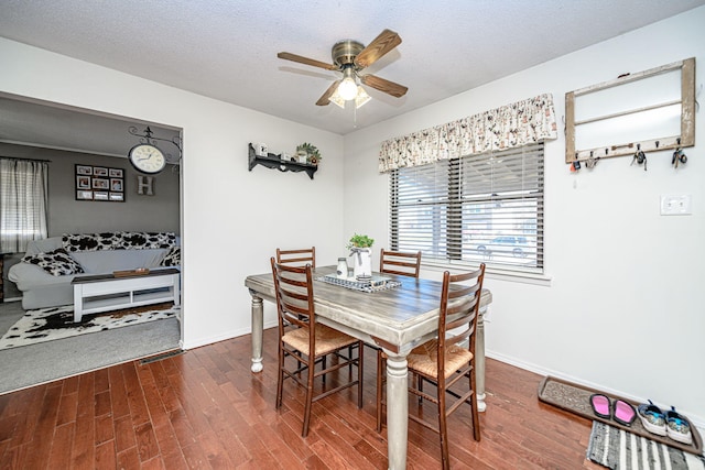 dining space with a ceiling fan, wood finished floors, and baseboards