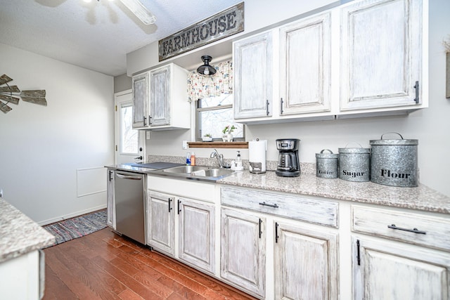 kitchen featuring a sink, a textured ceiling, light countertops, dishwasher, and dark wood-style flooring