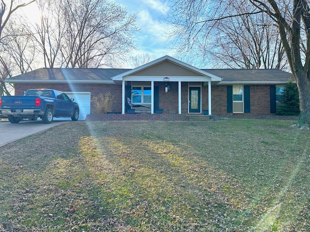 ranch-style home with a garage, a front yard, brick siding, and driveway