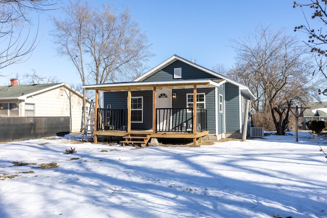 bungalow featuring cooling unit, a porch, and fence