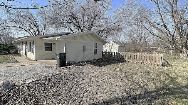 view of home's exterior featuring fence