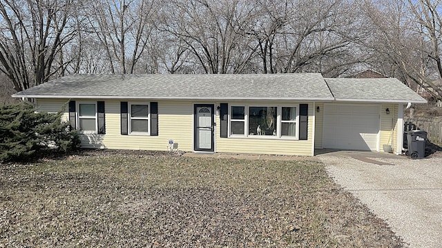 single story home with a garage, roof with shingles, and driveway