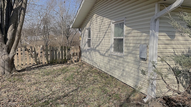 view of side of home with fence