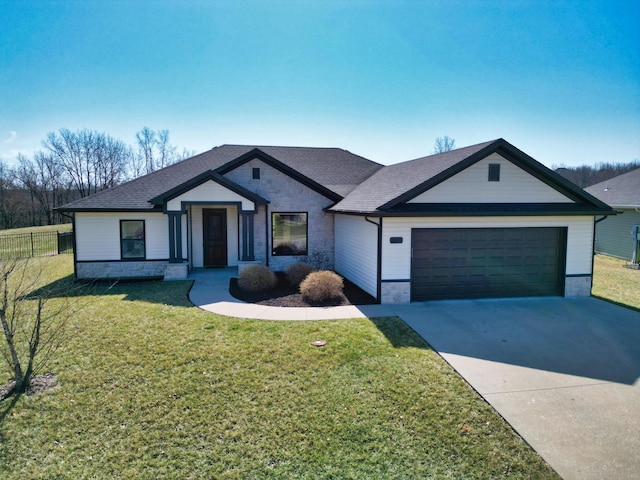 view of front of home with an attached garage, concrete driveway, a front yard, and fence