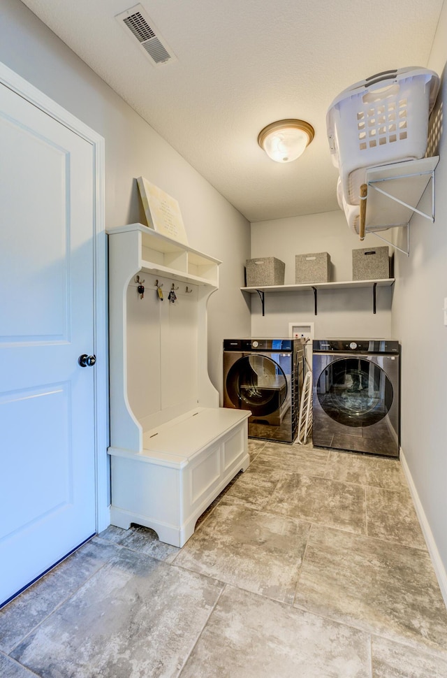 washroom with visible vents, independent washer and dryer, laundry area, and baseboards