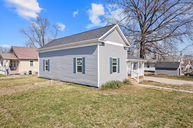 view of property exterior with a yard and roof with shingles