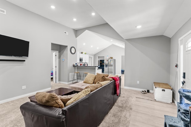 living area with visible vents, recessed lighting, baseboards, and lofted ceiling