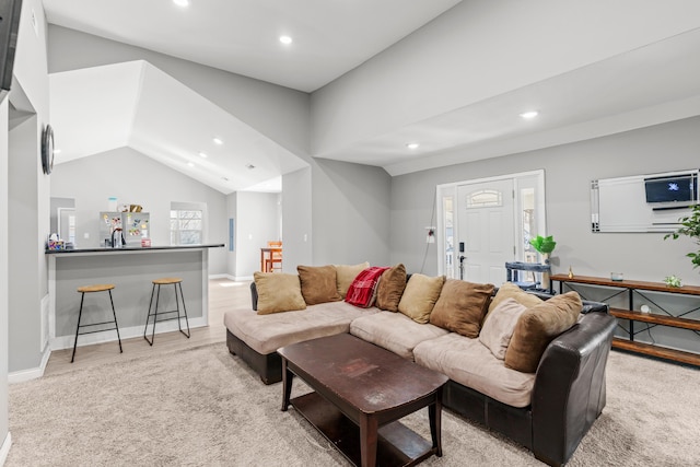 living area with light wood-style floors, recessed lighting, baseboards, and vaulted ceiling