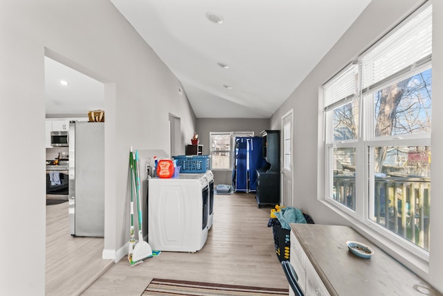 washroom with light wood-type flooring, recessed lighting, separate washer and dryer, baseboards, and laundry area