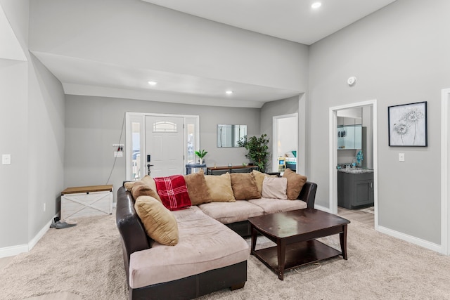 living room with recessed lighting, baseboards, and light colored carpet