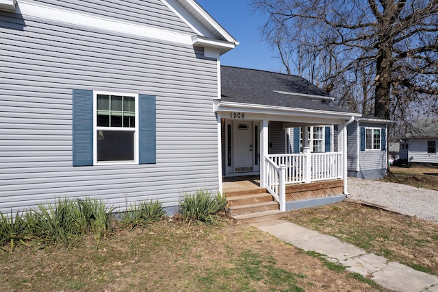 view of front of property with covered porch and roof with shingles