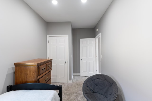 bedroom with recessed lighting, baseboards, and light carpet