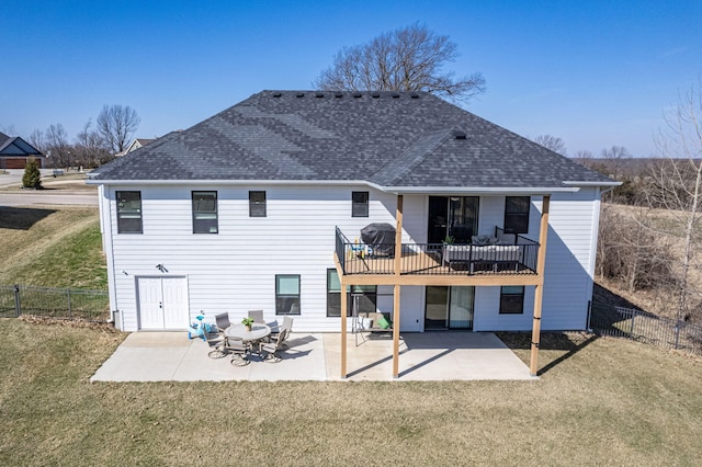 back of property with a patio area, a lawn, a shingled roof, and a fenced backyard