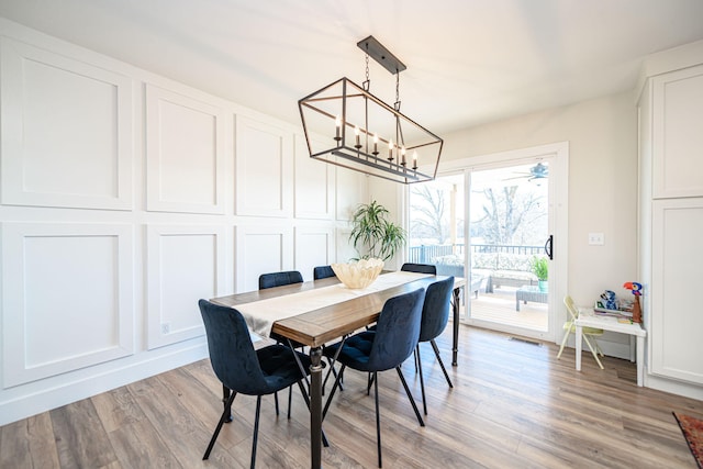 dining area with visible vents, a chandelier, and light wood-type flooring