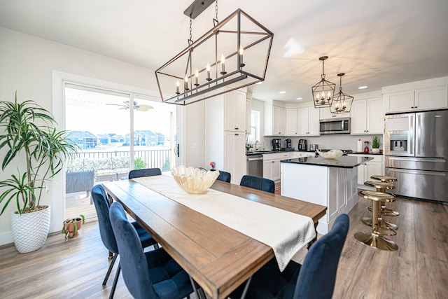 dining room featuring recessed lighting, an inviting chandelier, and wood finished floors