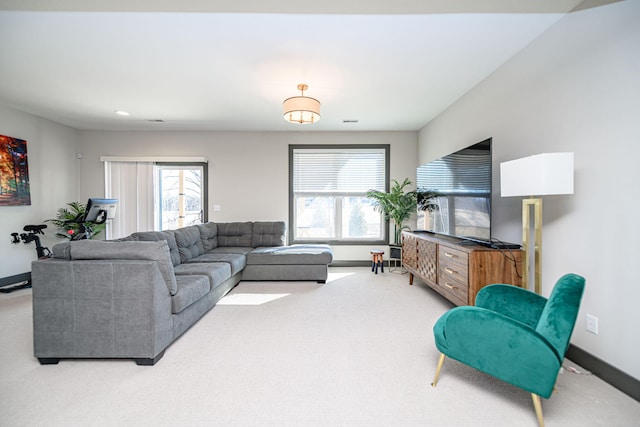 living room with plenty of natural light, carpet flooring, and baseboards