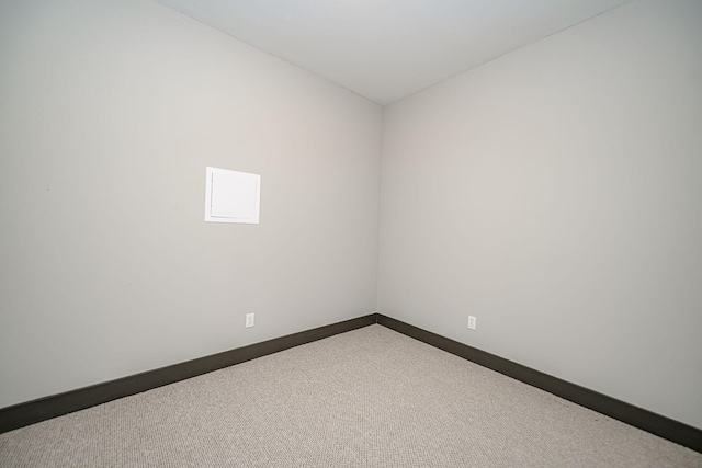 carpeted spare room with baseboards