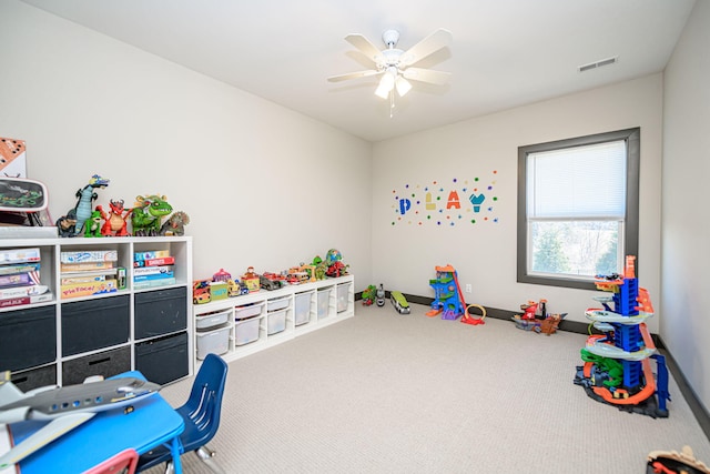 playroom with carpet, a ceiling fan, visible vents, and baseboards