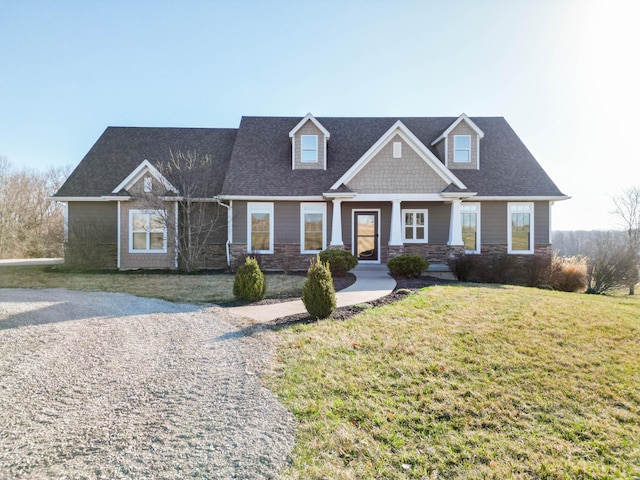 view of front of property featuring stone siding and a front lawn