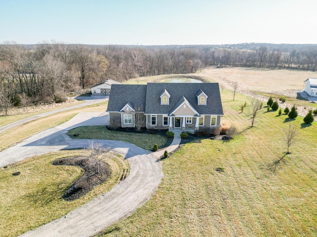 drone / aerial view featuring a wooded view