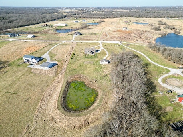 drone / aerial view featuring a water view and a rural view