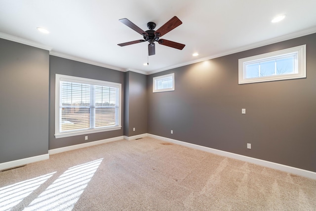 empty room with crown molding, ceiling fan, baseboards, light carpet, and recessed lighting