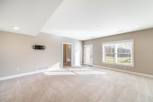 unfurnished living room featuring recessed lighting, baseboards, visible vents, and light carpet