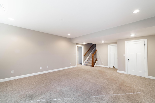 finished basement featuring stairs, recessed lighting, and light carpet