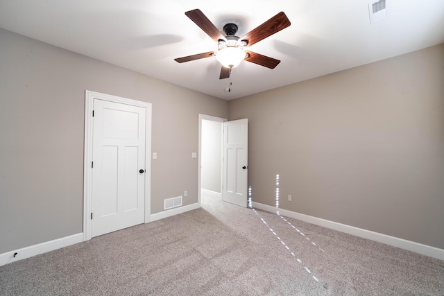 unfurnished bedroom featuring visible vents, baseboards, and carpet