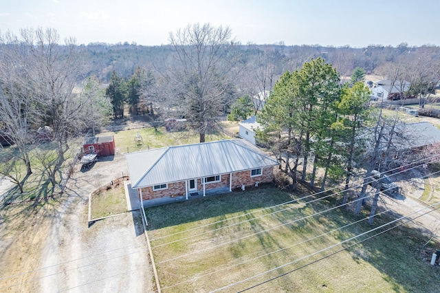 birds eye view of property with a view of trees