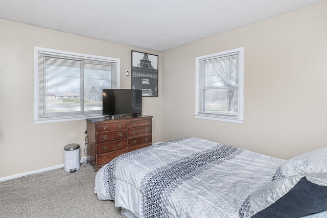 carpeted bedroom with baseboards