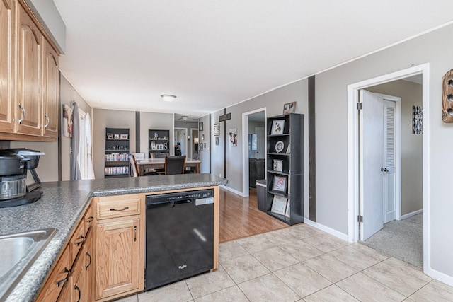 kitchen with baseboards, a peninsula, light tile patterned flooring, a sink, and dishwasher