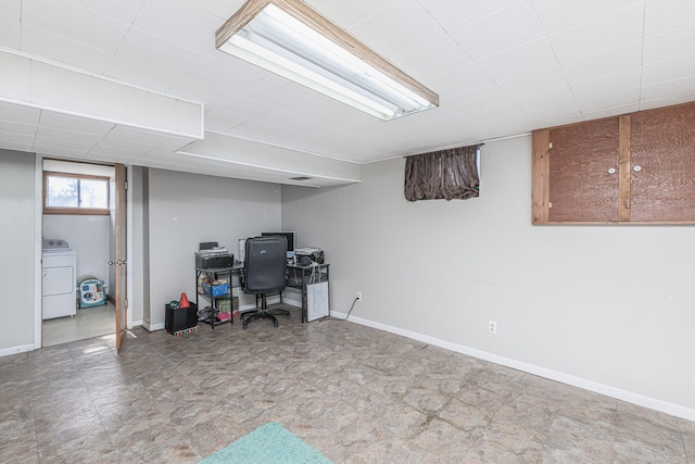 office space featuring baseboards and washer / dryer