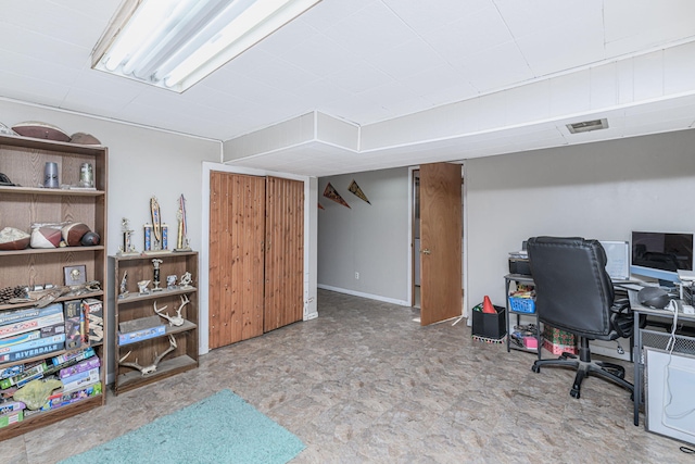 office with tile patterned floors and visible vents