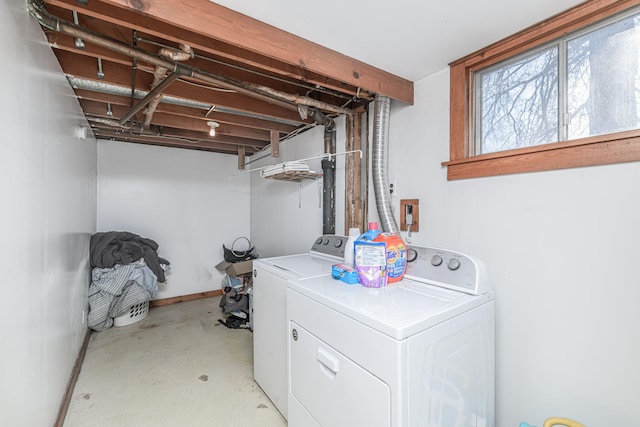 laundry room with washer and clothes dryer, laundry area, and baseboards