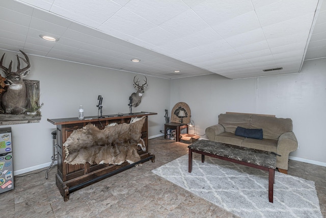 living room with recessed lighting, visible vents, and baseboards