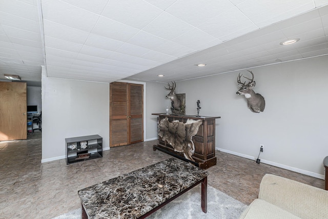 living area featuring recessed lighting and baseboards