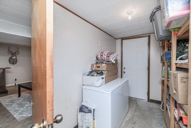 laundry area with baseboards