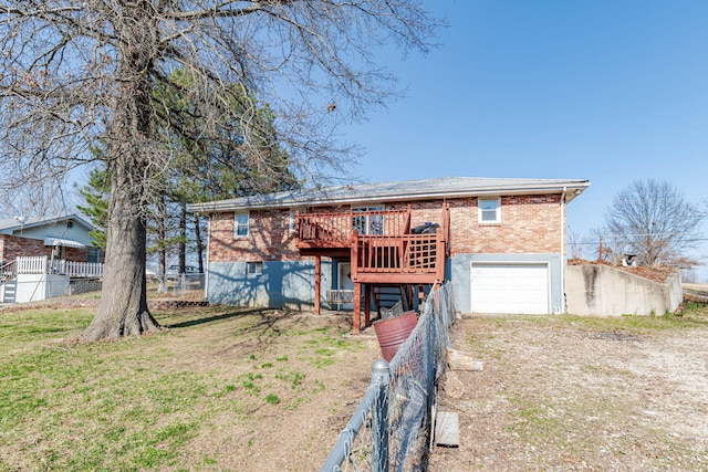 view of front of property featuring a deck, dirt driveway, fence, a garage, and brick siding